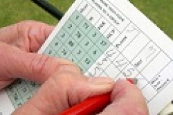 Golfer using a scorecard.