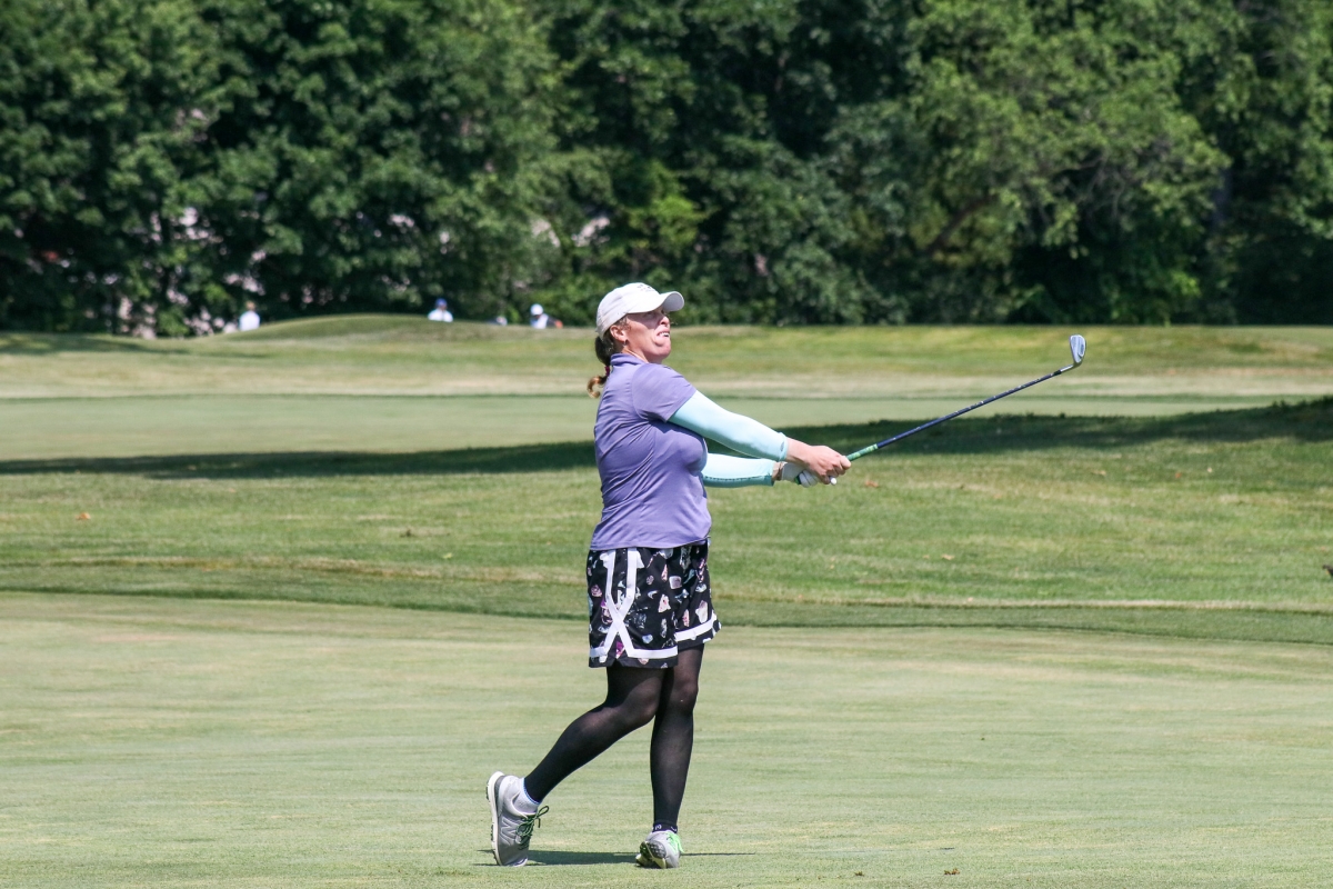 women swinging a golf club